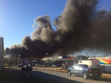 Clouds of thick smoke cover the area during the Universal Rubber Products plant fire.