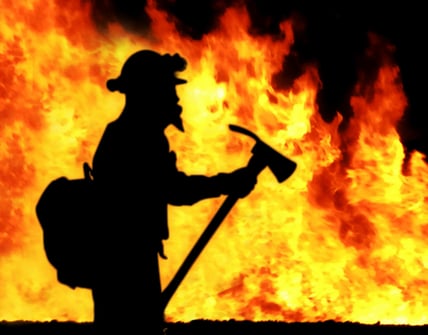 fire fighter in front of large fire