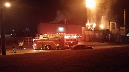 Flames of burning rubber dust shoot out of ventilation vents at the Jasper Rubber Products Plant